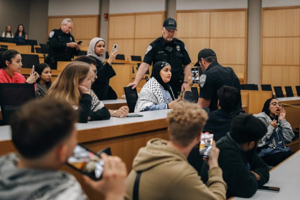 A police officer tells Sajida Megariaf to leave a Turning Point even on Tuesday, Feb. 27, 2024, at University of Kentucky in Lexington, Kentucky. Photo by Najma Amarkhail