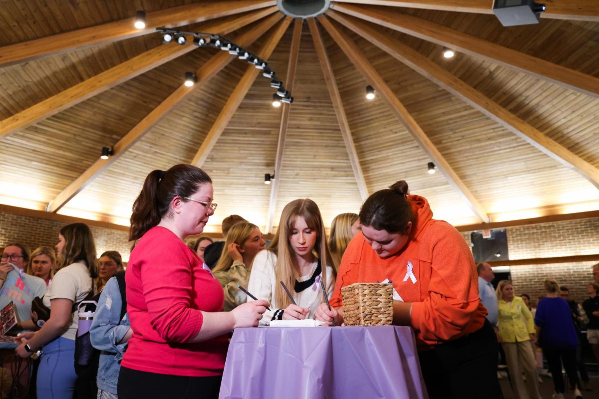 Friends and family of Madison Becknell gather to mourn her death and sign a notebook to be given to her family during a vigil on Wednesday, March 6, 2024, at Baptist Campus Ministry in Lexington, Kentucky. Photo by Abbey Cutrer | Staff