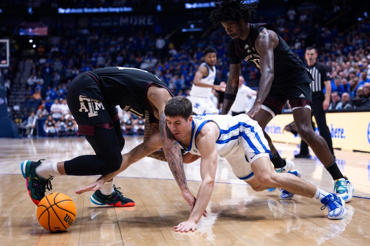 Kentucky guard Reed Sheppard (15) goes for a loose ball during the No. 2 Kentucky vs. No. 7 Texas A&M mens basketball match in the SEC Tournament quarterfinals on Friday, March 15, 2024, at Bridgestone Arena in Nashville, Tennessee. Kentucky lost 97-87. Photo by Samuel Colmar | Staff