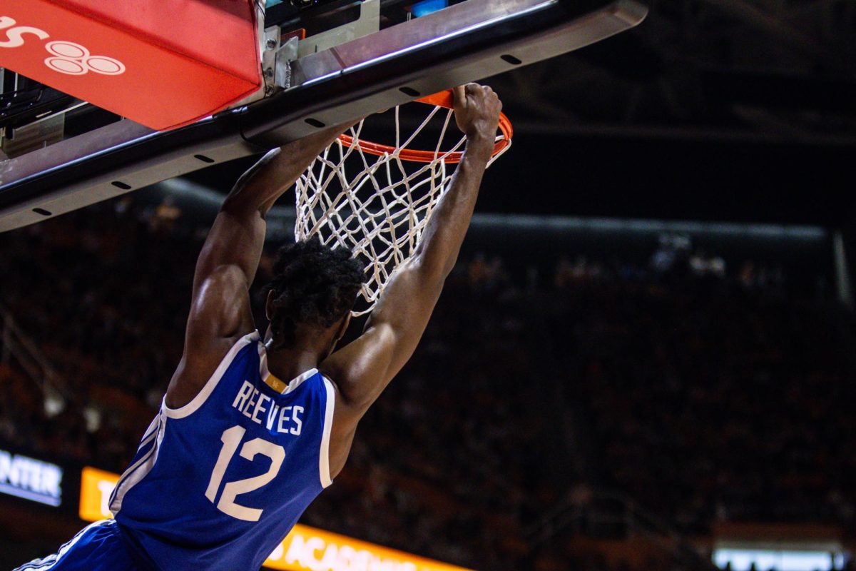 Kentucky guard Antione Reeves hangs on the rim during the Kentucky men’s basketball game vs. Tennessee on Saturday, March 9, 2024, at the Food City Center in Knoxville, Tennessee. Kentucky won 85-81. Photo by Isaiah Pinto | Staff