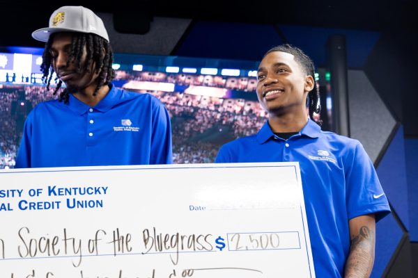 Rob Dillingham smiles while being handed the check after winning the charity matches after the Rob Dillingham vs. Aaron Bradshaw NBA 2K Charity Match on Thursday, Feb. 29, 2024, at the UKFCU eSports Lounge in Lexington, Kentucky. Photo by Samuel Colmar | Staff