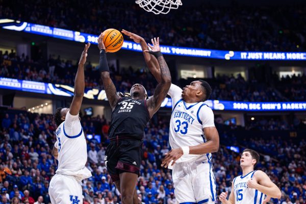 Kentucky defenders go to block a shot during the No. 2 Kentucky vs. No. 7 Texas A&M mens basketball match in the SEC Tournament quarterfinals on Friday, March 15, 2024, at Bridgestone Arena in Nashville, Tennessee. Kentucky lost 97-87. Photo by Samuel Colmar | Staff