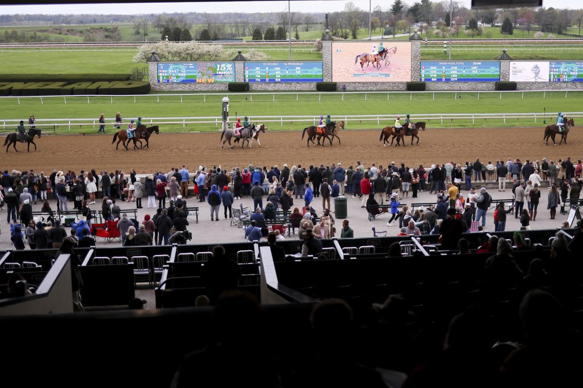 People watch as jockeys and their horses take to the track at the start of the third race on opening day during the Spring meet on Friday, April 5, 2024, at Keeneland in Lexington, Kentucky. Photo by Matthew Mueller | Staff