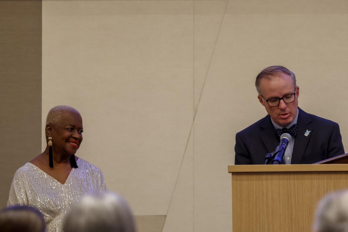 Duane Bonifer introduces Betty Winston Bayé to the stage as he prepares to induct her into the Kentucky Journalism Hall of Fame on Tuesday, April 9, 2024, at University of Kentucky in Lexington, Kentucky. Photo by Matthew Mueller | Staff