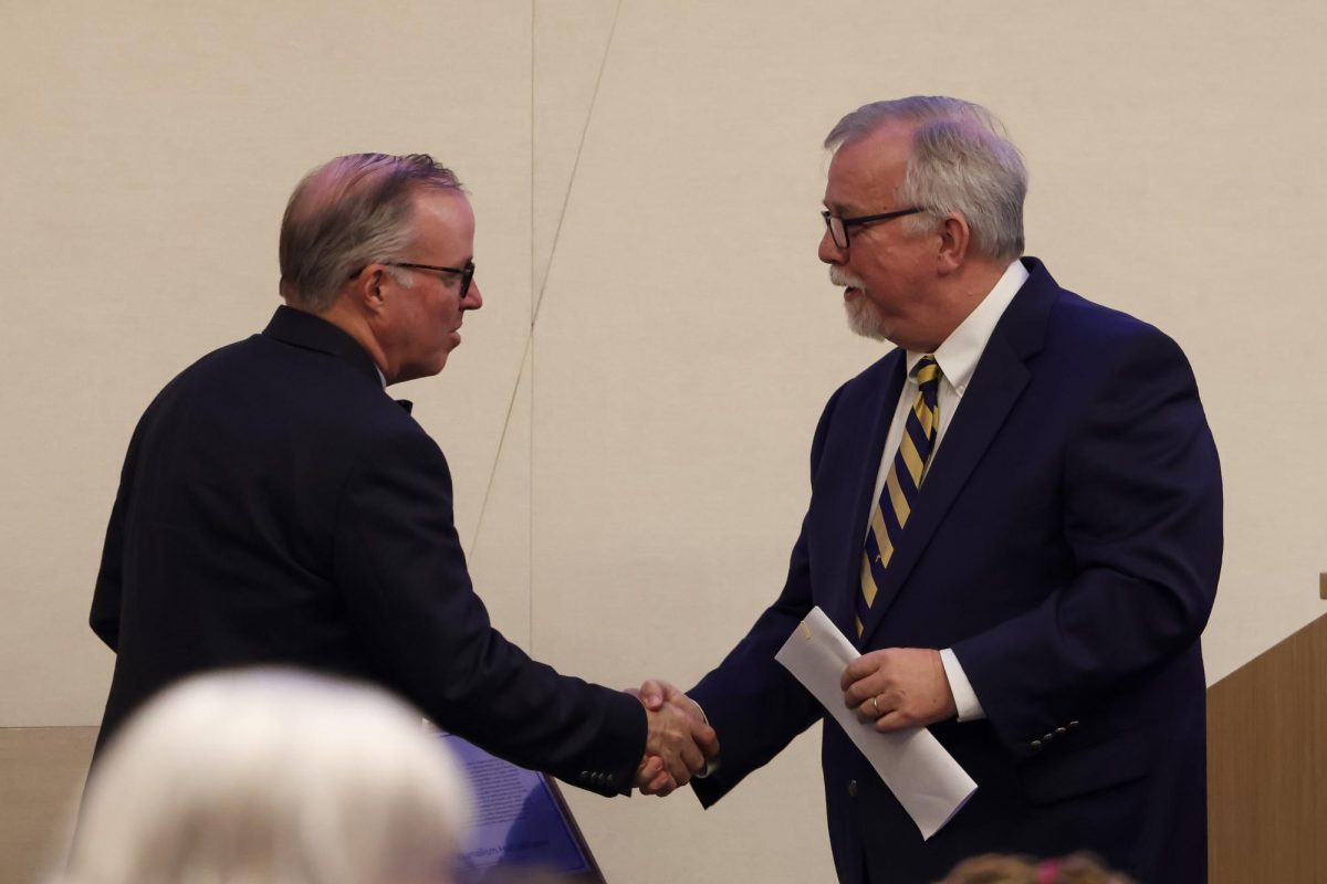 Duane Bonifer congratulates Paul Prather on being inducted into the Kentucky Journalism hall of Fame on Tuesday, April 9, 2024, at University of Kentucky in Lexington, Kentucky. Photo by Matthew Mueller | Staff