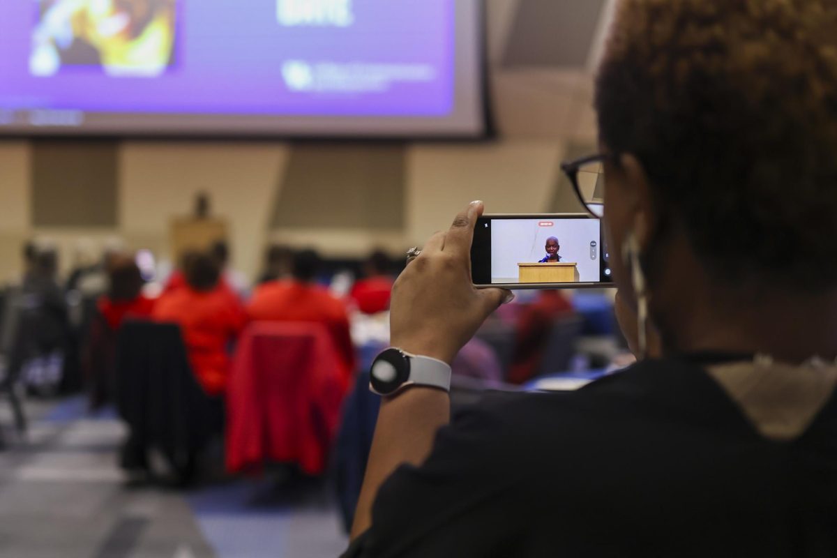 Attendee films Betty Winston Bayé acceptance speech during the Kentucky Journalism Hall of Fame induction ceremony on Tuesday, April 9, 2024, at University of Kentucky in Lexington, Kentucky. Photo by Matthew Mueller | Staff