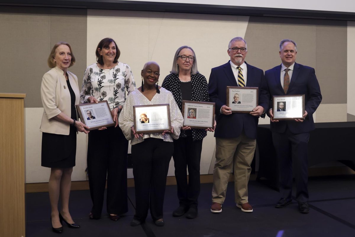 Deborah Yetter, Jean Porteron, Betty Winston Bayé, Deborah Taylor Givens, Paul Prather, and Peter Baniak pose for a photo after the Kentucky Journalism Hall of fame induction ceremony on Tuesday, April 9, 2024, at University of Kentucky in Lexington, Kentucky. Photo by Matthew Mueller | Staff