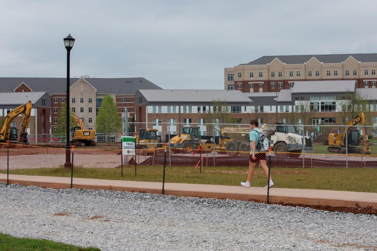 Student walks past construction taking place the South Lawn on Wednesday, April 10, 2024, at University of Kentucky in Lexington, Kentucky. Photo by Christian Kantosky | Staff
