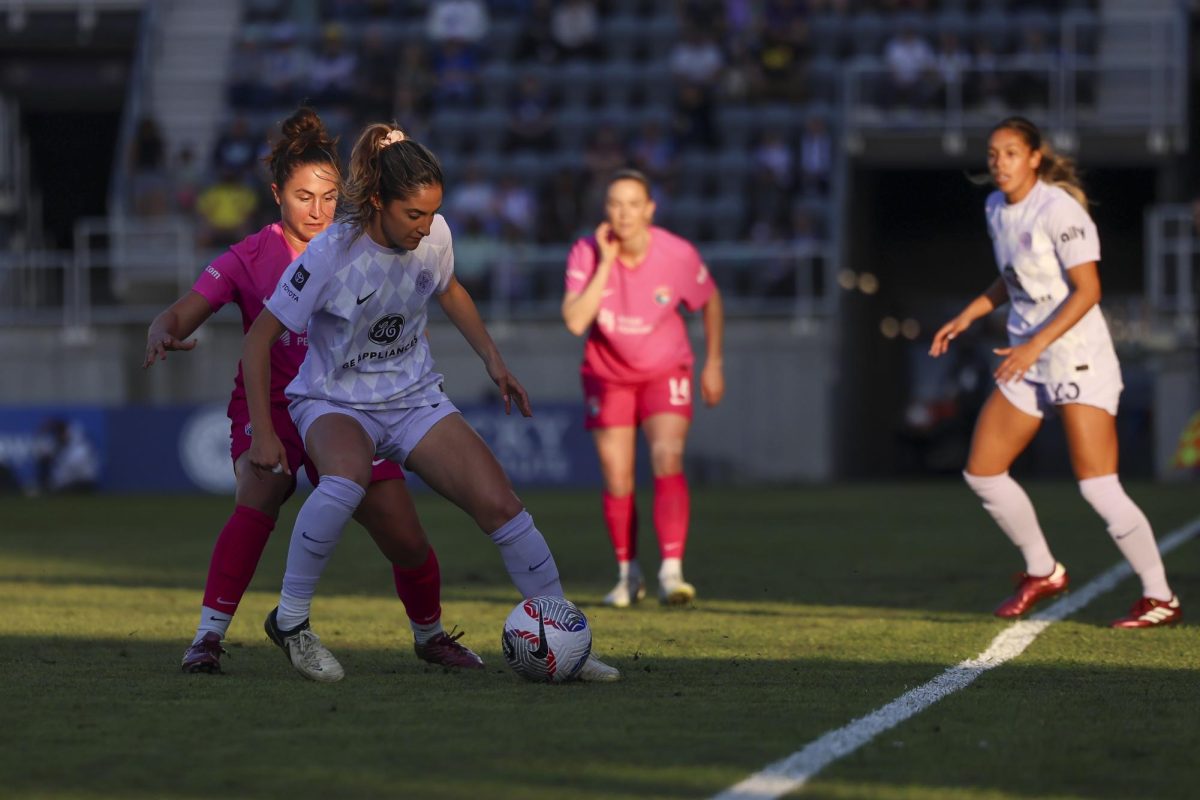 Savannah DeMelo fights for the ball on Saturday, April 13, 2024, at Lynn Family Stadium in Louisville, Kentucky. Racing FC tied 0-0 with San Diego Wave.  Photo by Matthew Mueller | Staff