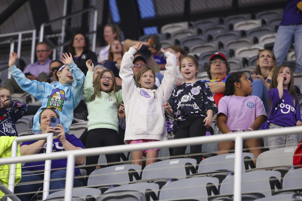 Fans wave for a chance to be on the video board on Saturday, April 13, 2024, at Lynn Family Stadium in Louisville, Kentucky. Racing FC tied 0-0 with San Diego Wave.  Photo by Matthew Mueller | Staff