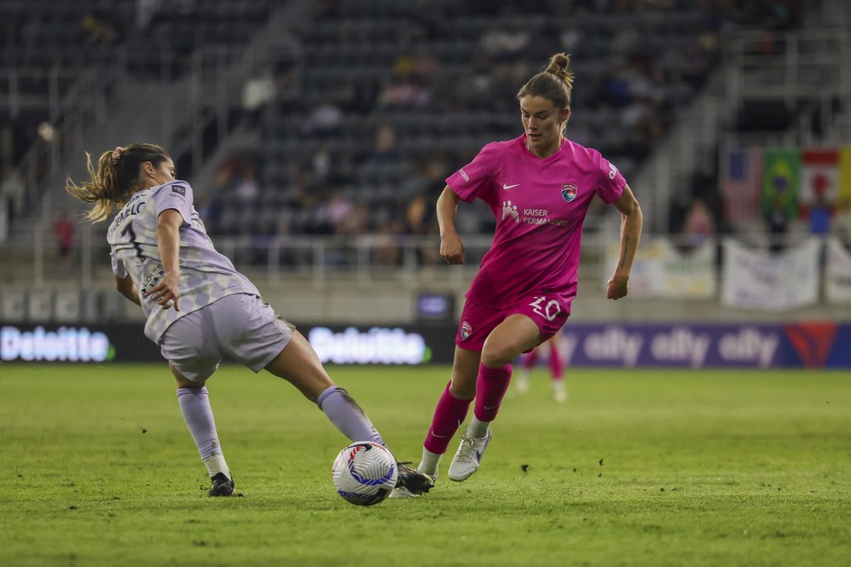 Christen Westphal drives the ball past a defender on Saturday, April 13, 2024, at Lynn Family Stadium in Louisville, Kentucky. Racing FC tied 0-0 with San Diego Wave.  Photo by Matthew Mueller | Staff