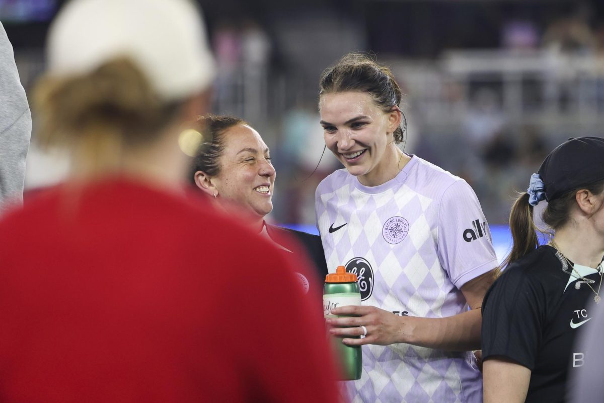 Taylor Flint smiles with a staff member on Saturday, April 13, 2024, at Lynn Family Stadium in Louisville, Kentucky. Racing FC tied 0-0 with San Diego Wave.  Photo by Matthew Mueller | Staff