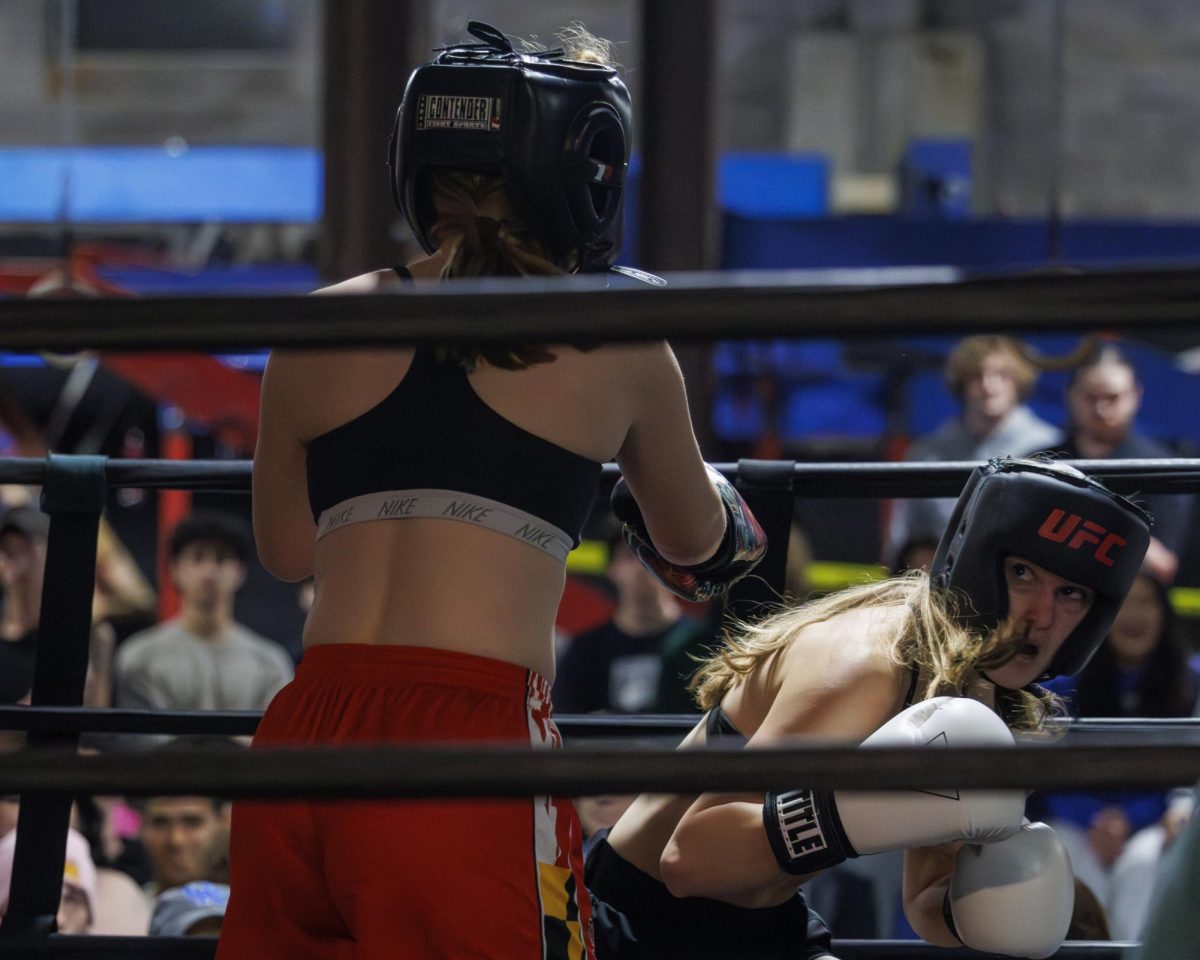 Danielle Eisemann dodges a punch by Emi Arzola during the UK Boxing club exhibition match on Friday, April 12, 2024, at Thrive Tribe Boxing club in Lexington, Kentucky. Photo by Matthew Mueller | Staff