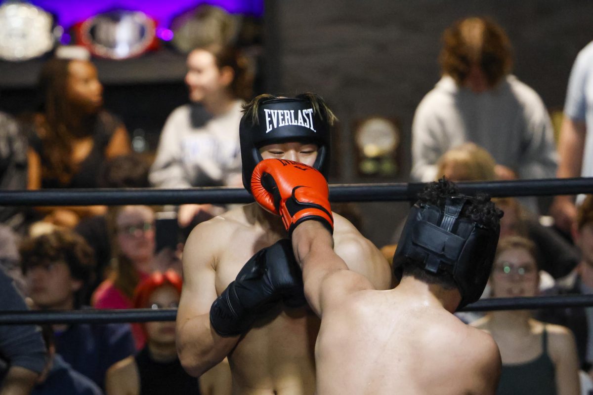 Juan Quijand lands a punch against Ricky Chen during the UK Boxing club exhibition match on Friday, April 12, 2024, at Thrive Tribe Boxing club in Lexington, Kentucky. Photo by Matthew Mueller | Staff