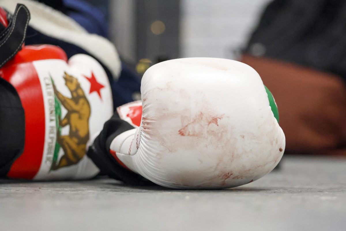 bloody gloves lay on the floor during the UK Boxing club exhibition match on Friday, April 12, 2024, at Thrive Tribe Boxing club in Lexington, Kentucky. Photo by Matthew Mueller | Staff