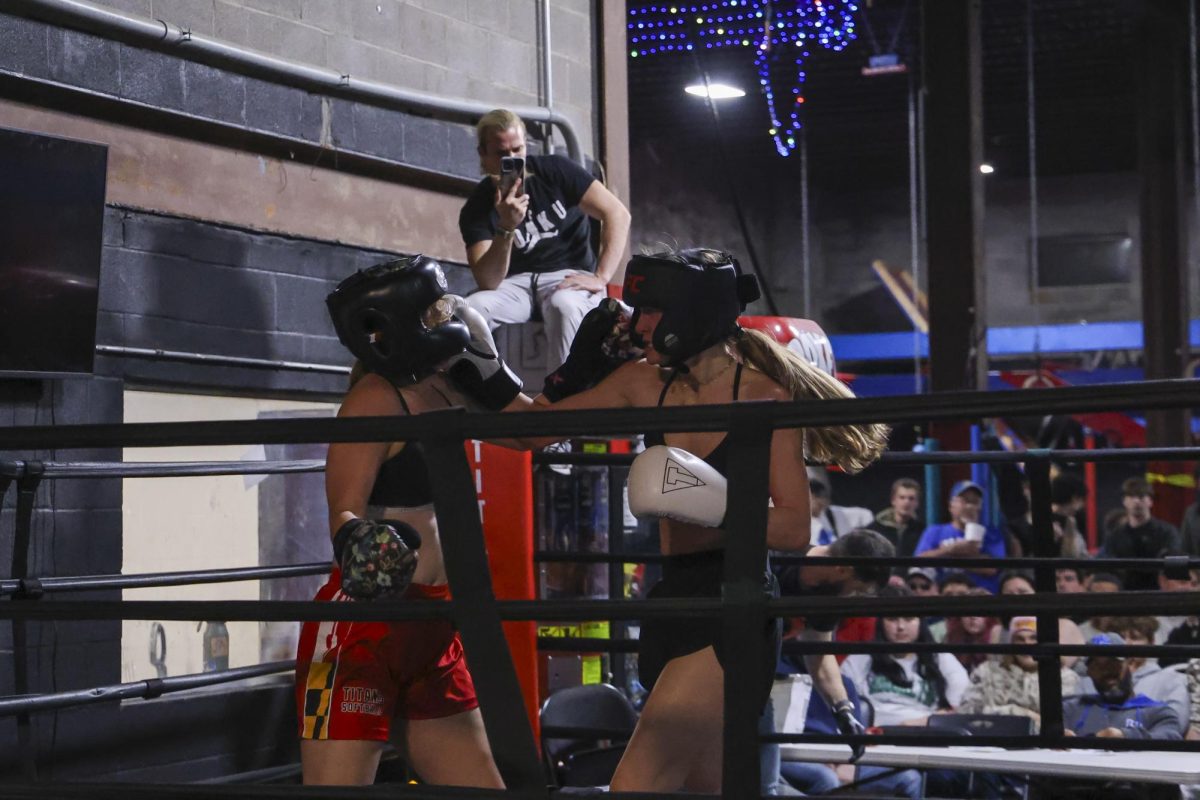 Danielle Eisemann lands a punch on Emi Arzola during the UK Boxing club exhibition match on Friday, April 12, 2024, at Thrive Tribe Boxing club in Lexington, Kentucky. Photo by Matthew Mueller | Staff