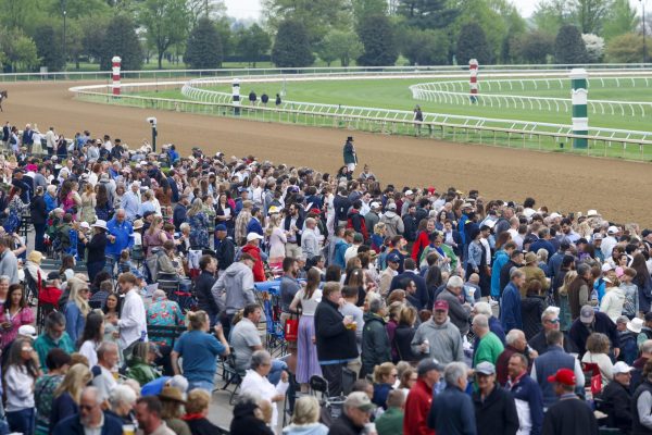 Crowds gather near the track to watch the first race of the day on Friday, April 19, 2024, at Keeneland During College day in Lexington, Kentucky. Photo by Matthew Mueller | Staff