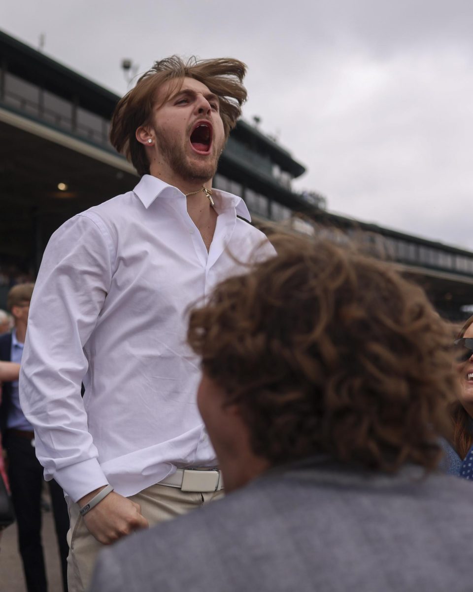 Boyson Lindloff cheers after horses complete their race on Friday, April 19, 2024, at Keeneland During College day in Lexington, Kentucky. Photo by Matthew Mueller | Staff
