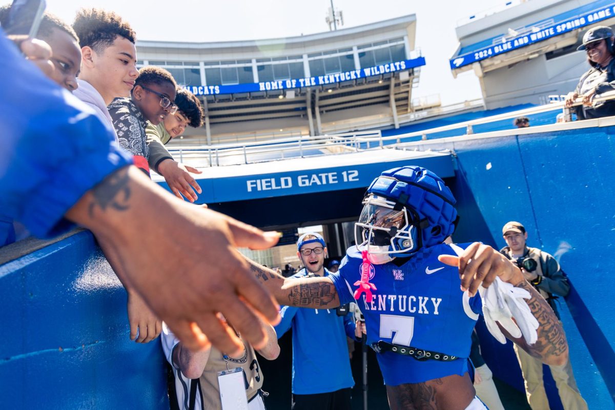 Kentucky wide receiver Barion Brown (7) high-fives fans as he exits the tunnel before the Kentucky Blue-White Spring football game on Saturday, April 13, 2024, at Kroger Field in Lexington, Kentucky. Photo by Samuel Colmar | Staff