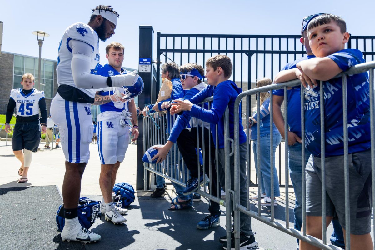 Kentucky players sign memorabilia for fans before the Kentucky Blue-White Spring football game on Saturday, April 13, 2024, at Kroger Field in Lexington, Kentucky. Photo by Samuel Colmar | Staff