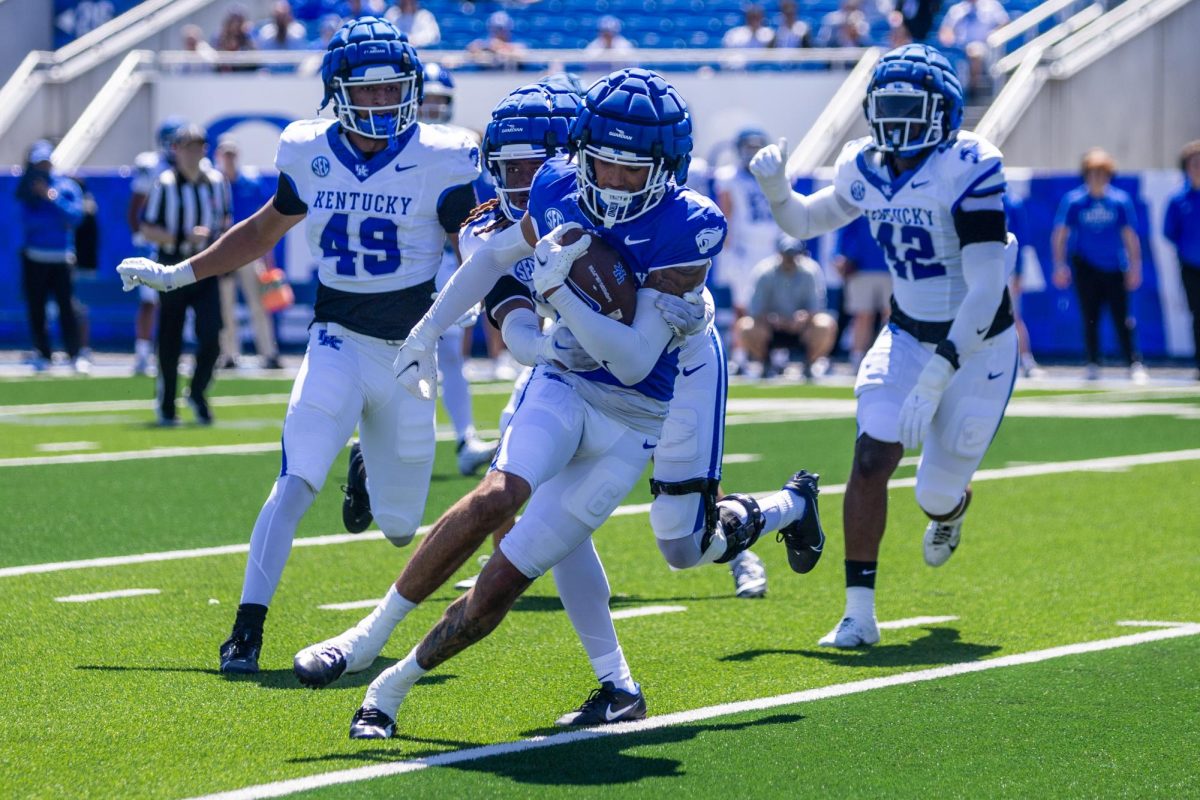 A Kentucky player runs with the ball during the Kentucky Blue-White Spring football game on Saturday, April 13, 2024, at Kroger Field in Lexington, Kentucky. Photo by Samuel Colmar | Staff