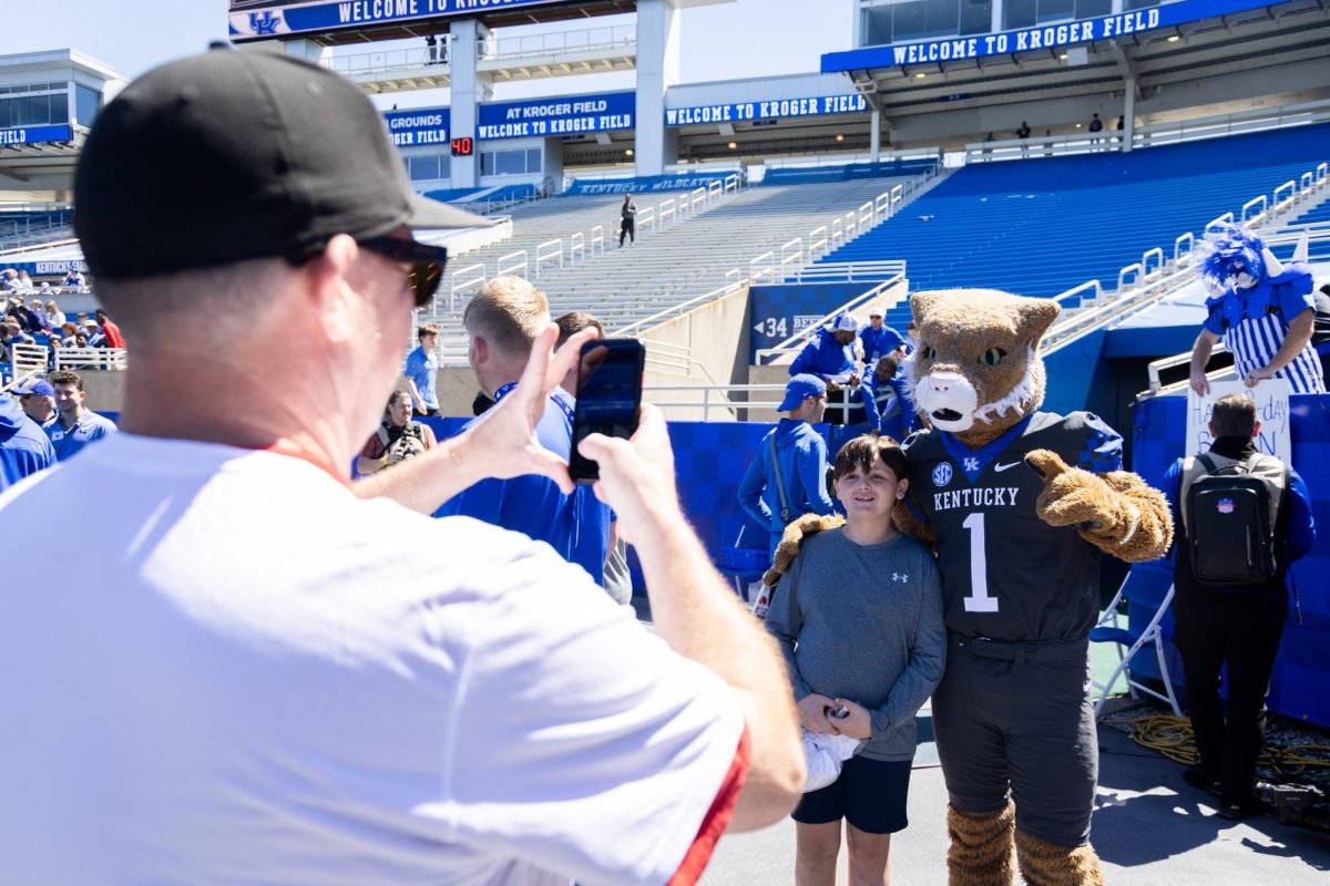 A fan takes a picture with a Kentucky mascot before the Kentucky Blue-White Spring football game on Saturday, April 13, 2024, at Kroger Field in Lexington, Kentucky. Photo by Samuel Colmar | Staff