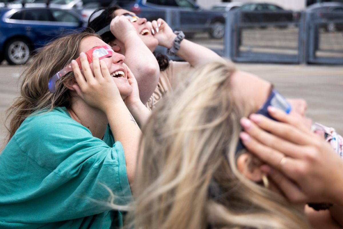 Students from the School of Visual Arts view the partial solar eclipse on Monday, April 8, 2024, on top of the Center Court Parking Garage in Lexington, Kentucky. Photo by Samuel Colmar | Staff