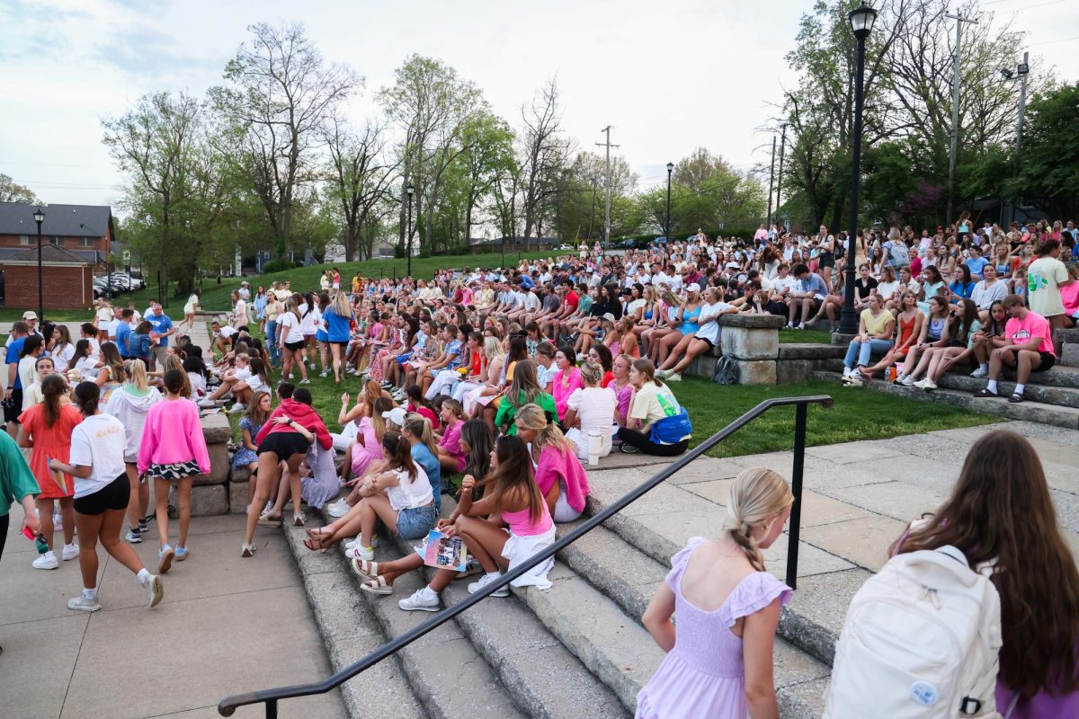 People find a place to sit before a vigil for UK dance team member Kate Kaufling on Monday, April 15, 2024, at Greek Park at the University of Kentucky in Lexington, Kentucky. Kaufling, a sophomore, died from bone cancer less than a year after her diagnosis. Photo by Abbey Cutrer | Staff