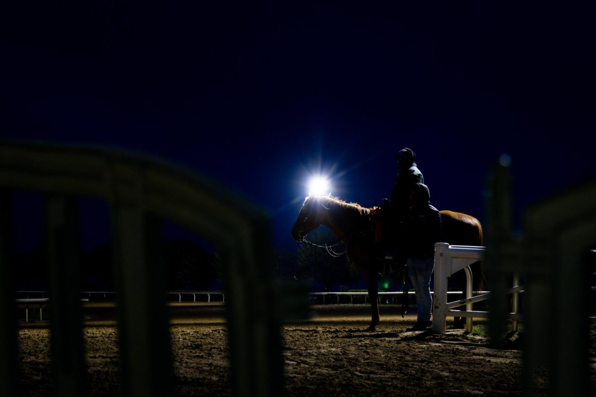 Exercise riders talk during morning training on the opening day of the Spring Meet on Friday, April 5, 2024, at Keeneland in Lexington, Kentucky. Photo by Samuel Colmar | Staff