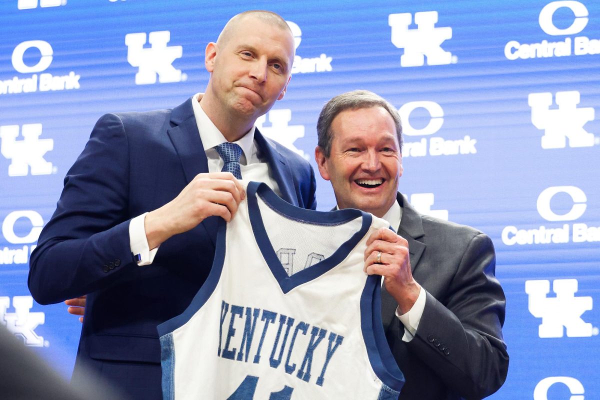 Mark+Pope+and+Kentucky+Athletics+Director+Mitch+Barnhart+hold+a+jersey+at+Pope%E2%80%99s+introductory+press+conference+as+the+new+head+coach+of+Kentucky+men%E2%80%99s+basketball+on+Sunday%2C+April+14%2C+2024%2C+at+Rupp+Arena+in+Lexington%2C+Kentucky.+Photo+by+Abbey+Cutrer+%7C+Staff