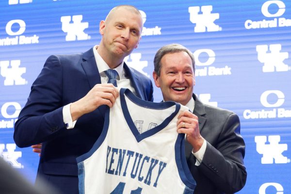Mark Pope and Kentucky Athletics Director Mitch Barnhart hold a jersey at Pope’s introductory press conference as the new head coach of Kentucky men’s basketball on Sunday, April 14, 2024, at Rupp Arena in Lexington, Kentucky. Photo by Abbey Cutrer | Staff