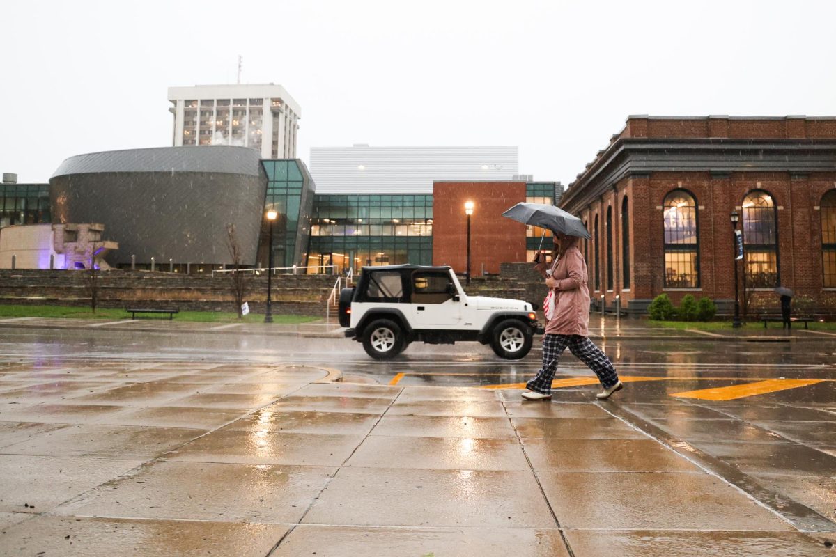 A student walks on campus in the rain on Tuesday, April 2, 2024, at the University of Kentucky in Lexington, Kentucky. Photo by Abbey Cutrer | Staff