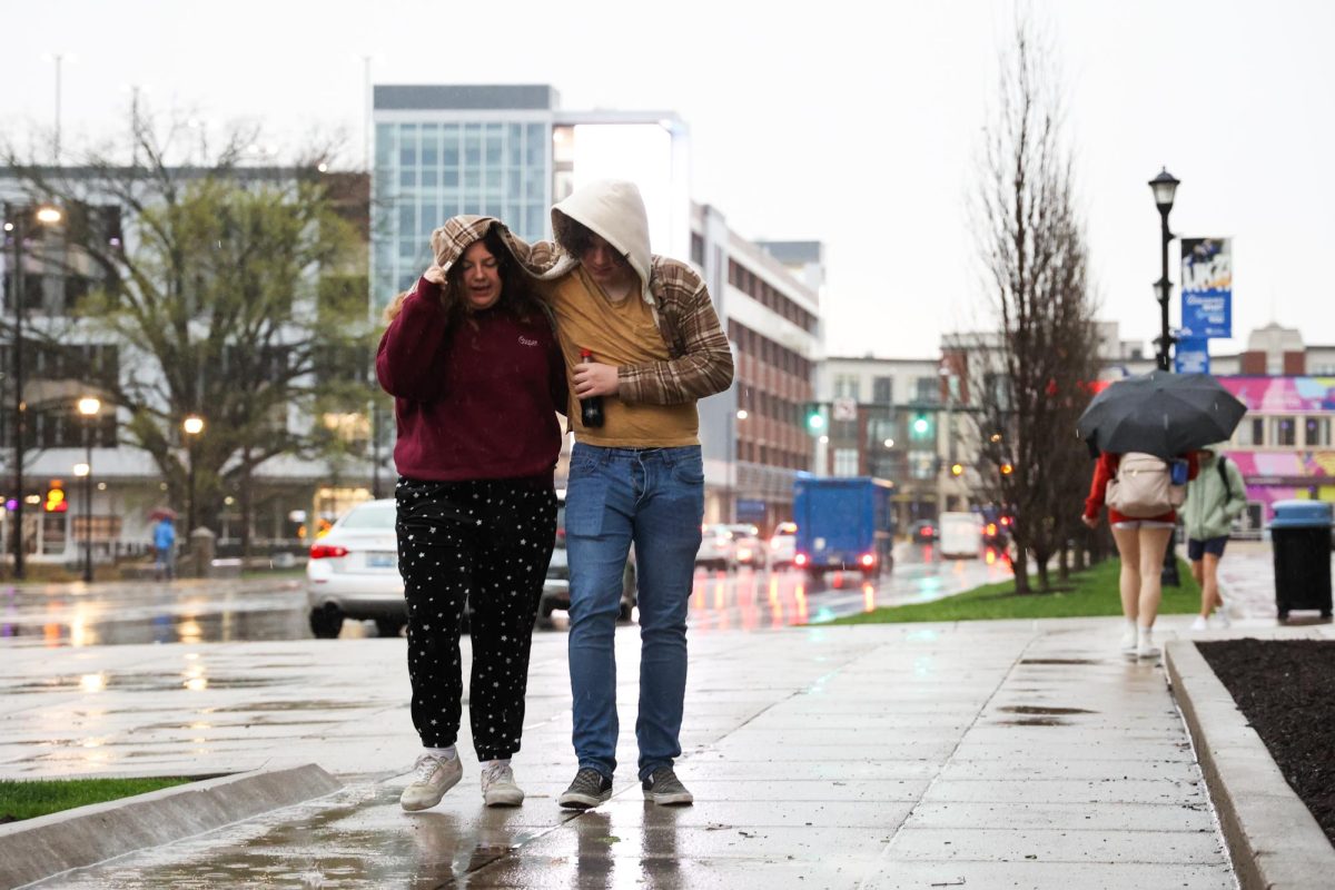 People walk on campus in the rain on Tuesday, April 2, 2024, at the University of Kentucky in Lexington, Kentucky. Photo by Abbey Cutrer | Staff