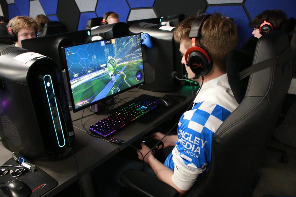 Kentucky esports Rocket League captain Jacob UnfryableApples Hunt fist bumps another player during a match at The Cornerstone | Photo provided by UKY eSports