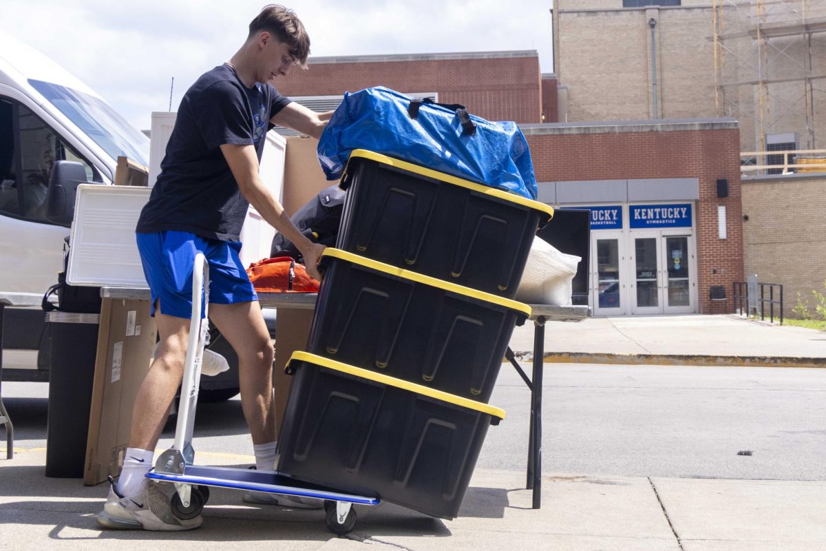 Freshman, Jack Robertson, 18, who is a business major tries to keep his boxes from falling off a cart while moving into Jewell Hall on Monday, Aug. 19, 2024, at the University of Kentucky in Lexington, Kentucky. During Big Blue Move-In. Photo by Matthew Mueller | Photo Editor  