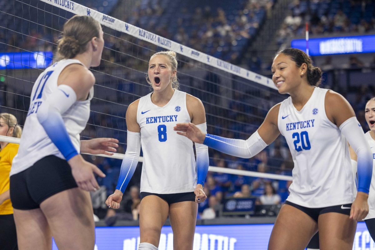 Kentucky’s Brooke Bultema, Brooklyn DeLeye, and Asia Thigpen celebrate after scoring a point on Friday, Aug. 30, 2024, at Memorial Coliseum in Lexington, Kentucky. Kentucky beat NKU 3-0. Photo by Matthew Mueller | Photo editor 
