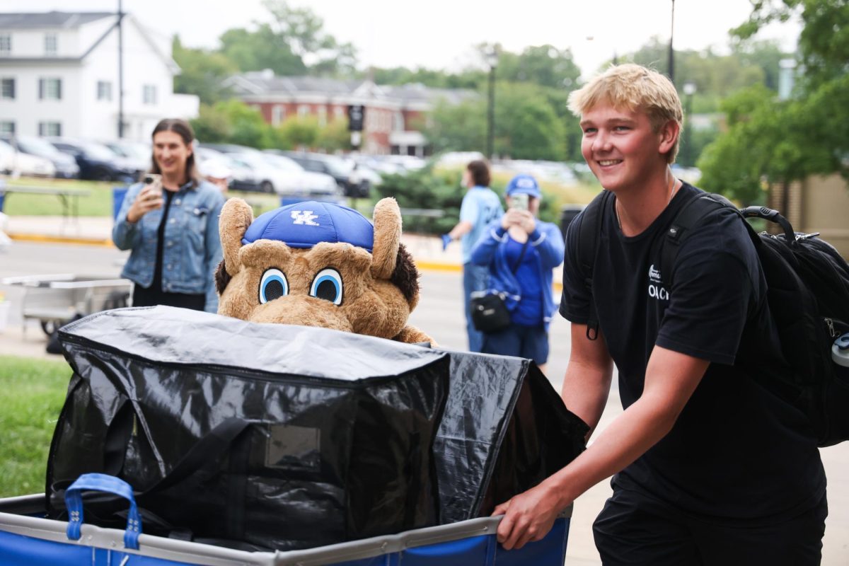 Scratch helps an incoming freshman push his cart during Big Blue Move-In on Monday, Aug. 19, 2024, at Jewell Hall at the University of Kentucky in Lexington, Kentucky. Photo by Abbey Cutrer | Staff