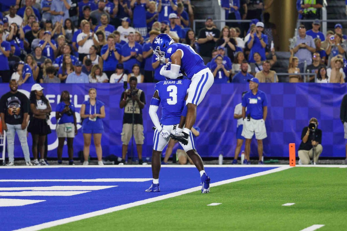 Kentucky inside linebacker Jason Dumas-Johnson jumps on Kentucky defensive back Alex Afari Jr. during the Kentucky vs Southern Miss football game on Saturday, Aug. 31, 2024, at Kroger Field in Lexington, Kentucky. Kentucky won 31-0. Photo by Sydney Yonker | Staff