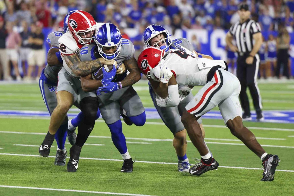 Kentucky Wildcats running back Jamarion Wilcox (10) runs through the block during the game between Kentucky and Georgia on Saturday, Sept. 14, 2024, at Kroger Field in Lexington, Kentucky. Kentucky lost to Georgia 13-12. Photo by Sydney Yonker | Staff