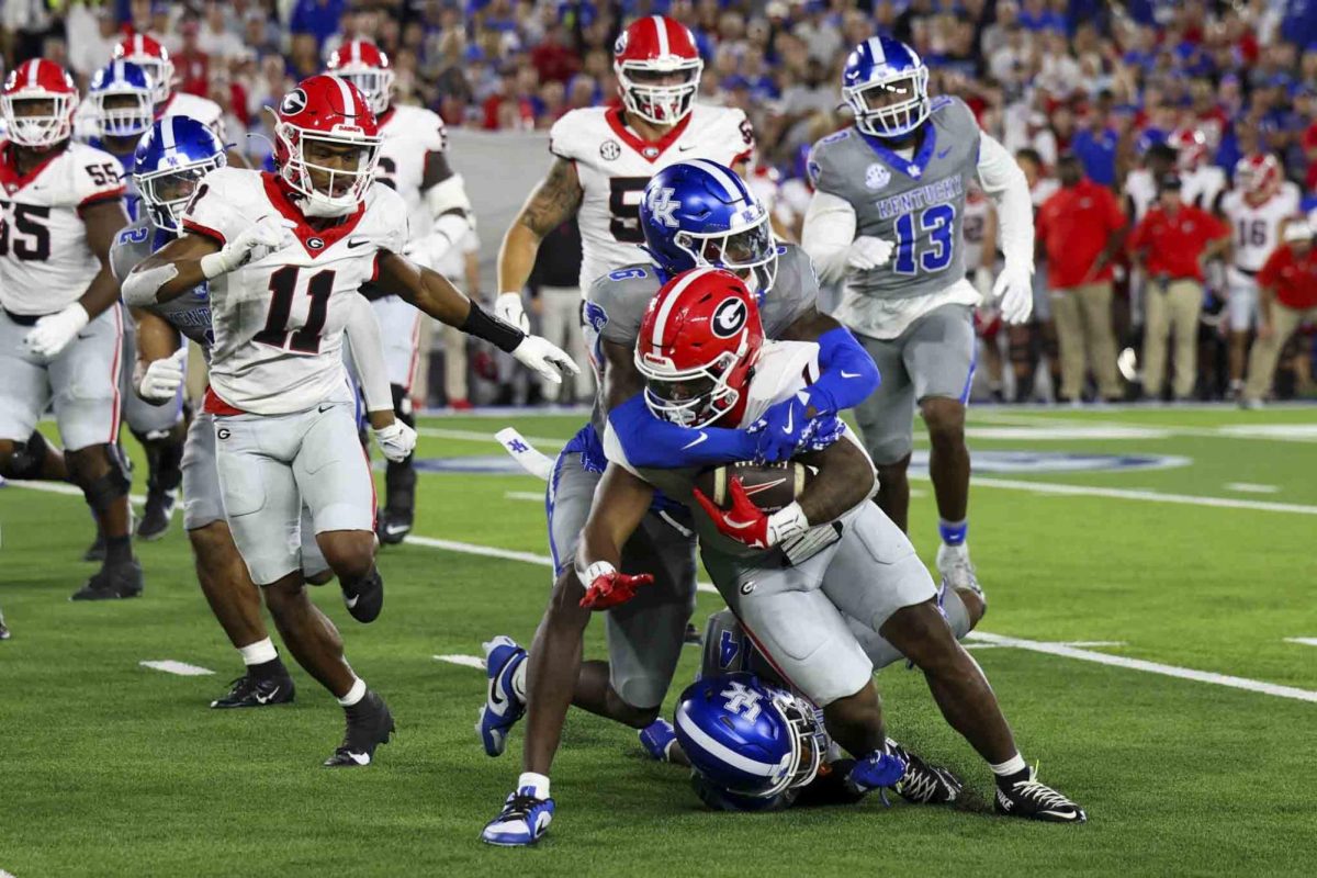 Kentucky Wildcats defensive back JQ Hardaway (6) tackles Georgia Bulldogs running back Trevor Etienne (1) during the game between Kentucky and Georgia on Saturday, Sept. 14, 2024, at Kroger Field in Lexington, Kentucky. Kentucky lost to Georgia 13-12. Photo by Sydney Yonker | Staff