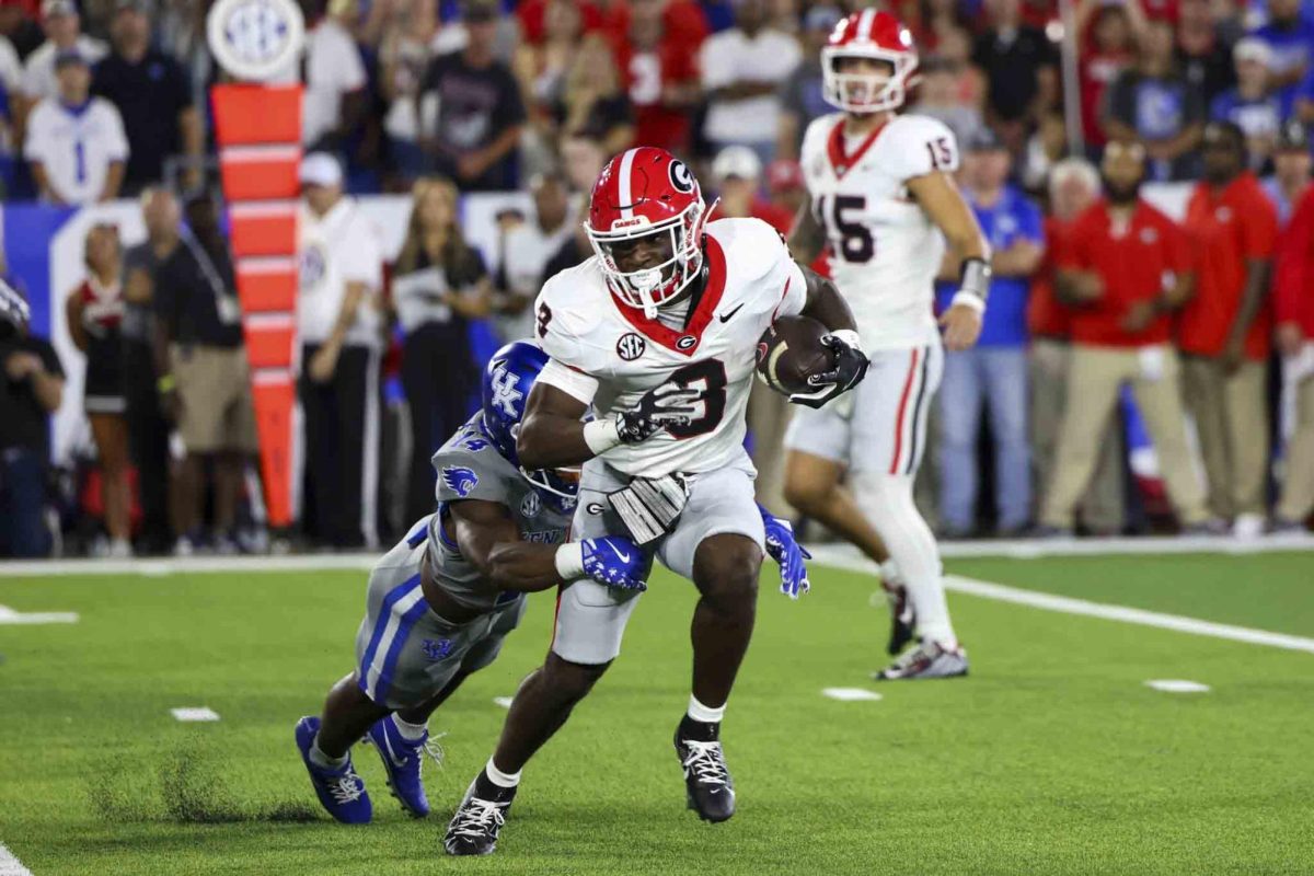 Kentucky Wildcats defensive back Ty Bryant (14) tackles Georgia Bulldogs running back Nate Frazier (3) during the game between Kentucky and Georgia on Saturday, Sept. 14, 2024, at Kroger Field in Lexington, Kentucky. Kentucky lost to Georgia 13-12. Photo by Sydney Yonker | Staff