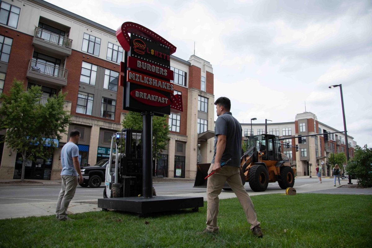 Workers secure the L8nite sign with a forklift outside Cornerstone Garage on Wednesday, Sep. 4, 2024, in Lexington, Kentucky. The sign is being torn down. Photo by Christian Kantosky | Staff