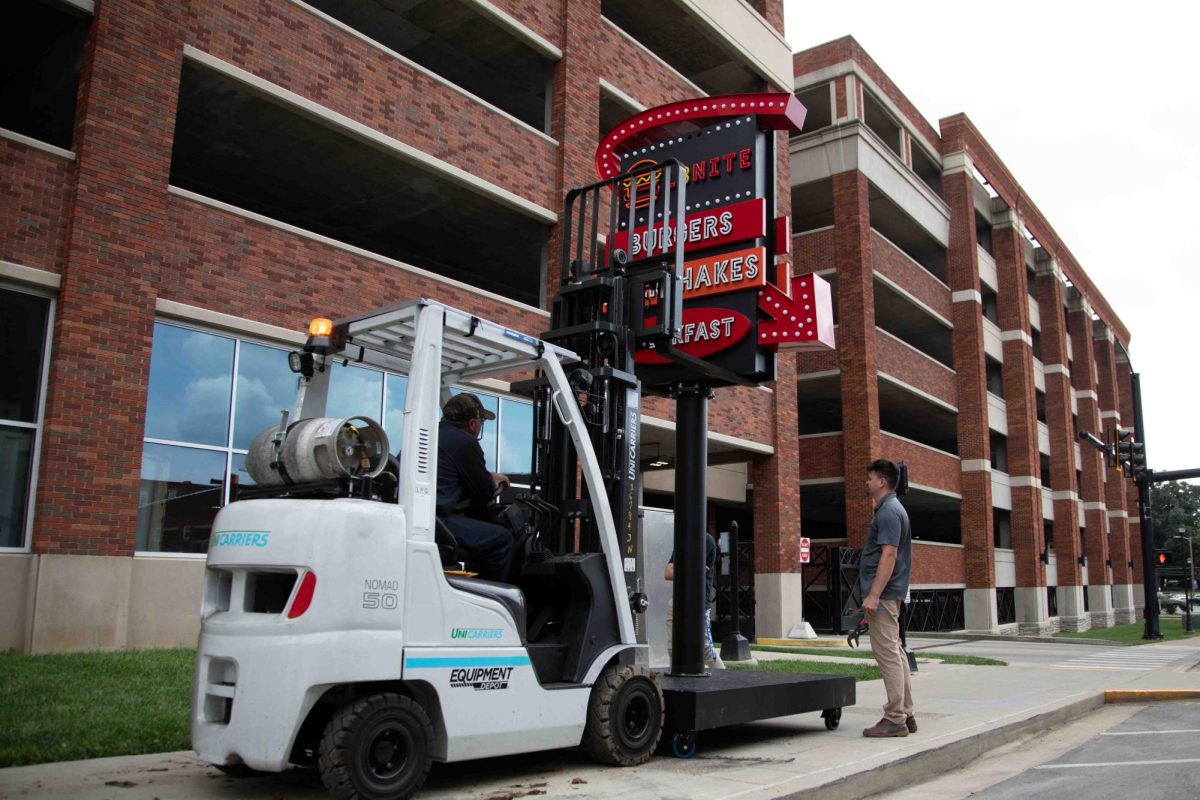 Workers secure the L8nite sign with a forklift outside Cornerstone Garage on Wednesday, Sep. 4, 2024, in Lexington, Kentucky. The sign is being torn down. Photo by Christian Kantosky | Staff