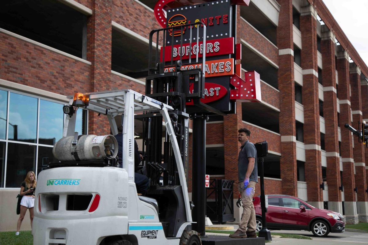 Workers secure the L8nite sign with a forklift outside Cornerstone Garage on Wednesday, Sep. 4, 2024, in Lexington, Kentucky. The sign is being torn down. Photo by Christian Kantosky | Staff