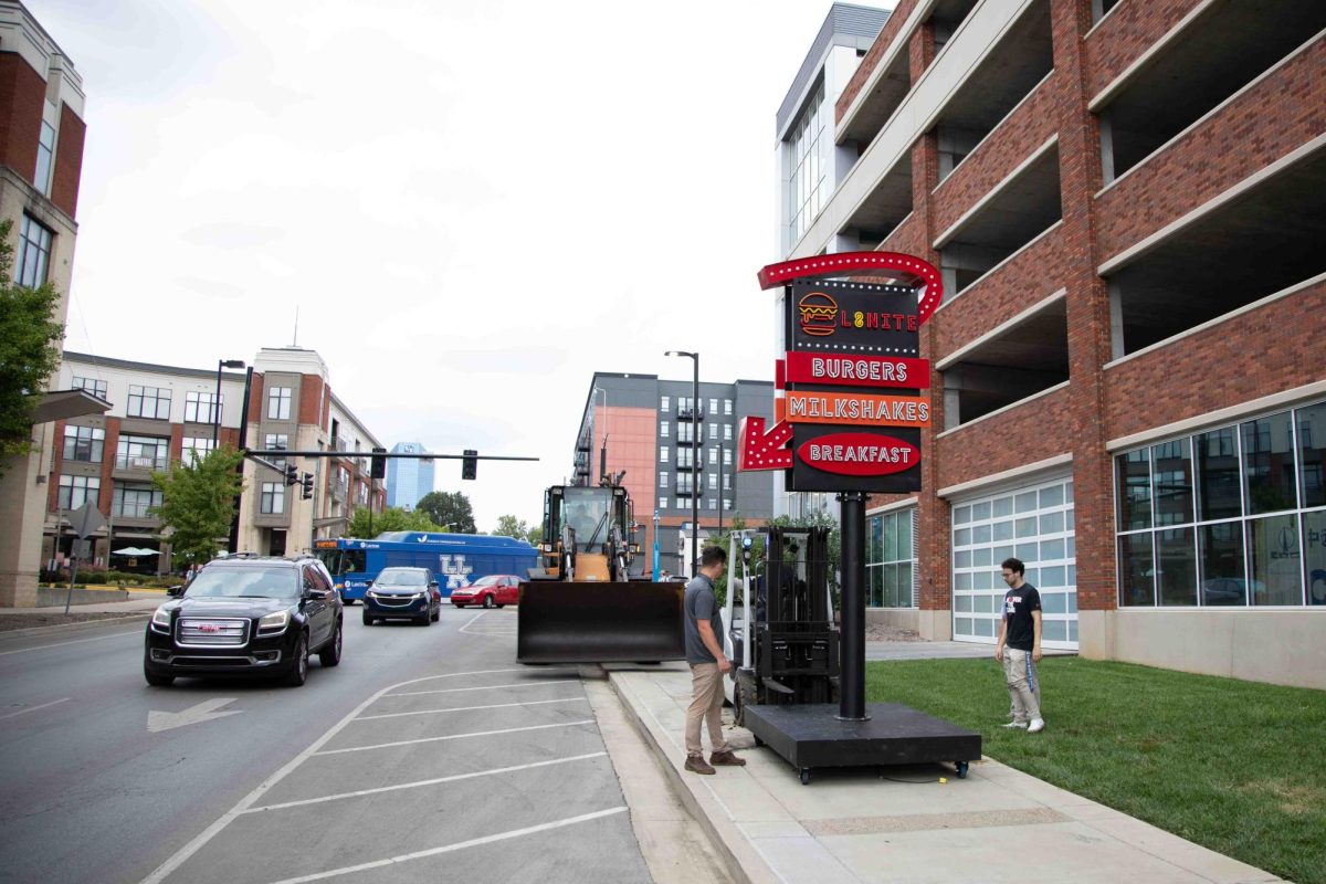 Workers secure the L8nite sign with a forklift outside Cornerstone Garage on Wednesday, Sep. 4, 2024, in Lexington, Kentucky. The sign is being torn down. Photo by Christian Kantosky | Staff