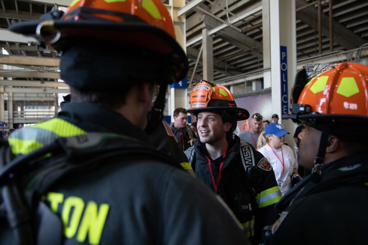 Firefighters converse as they wait to enter the stands for the 9/11 Memorial Stair Climb on Wednesday, Sept. 11, 2024, at Kroger Field in Lexington, Kentucky. Photo by Christian Kantosky | Staff