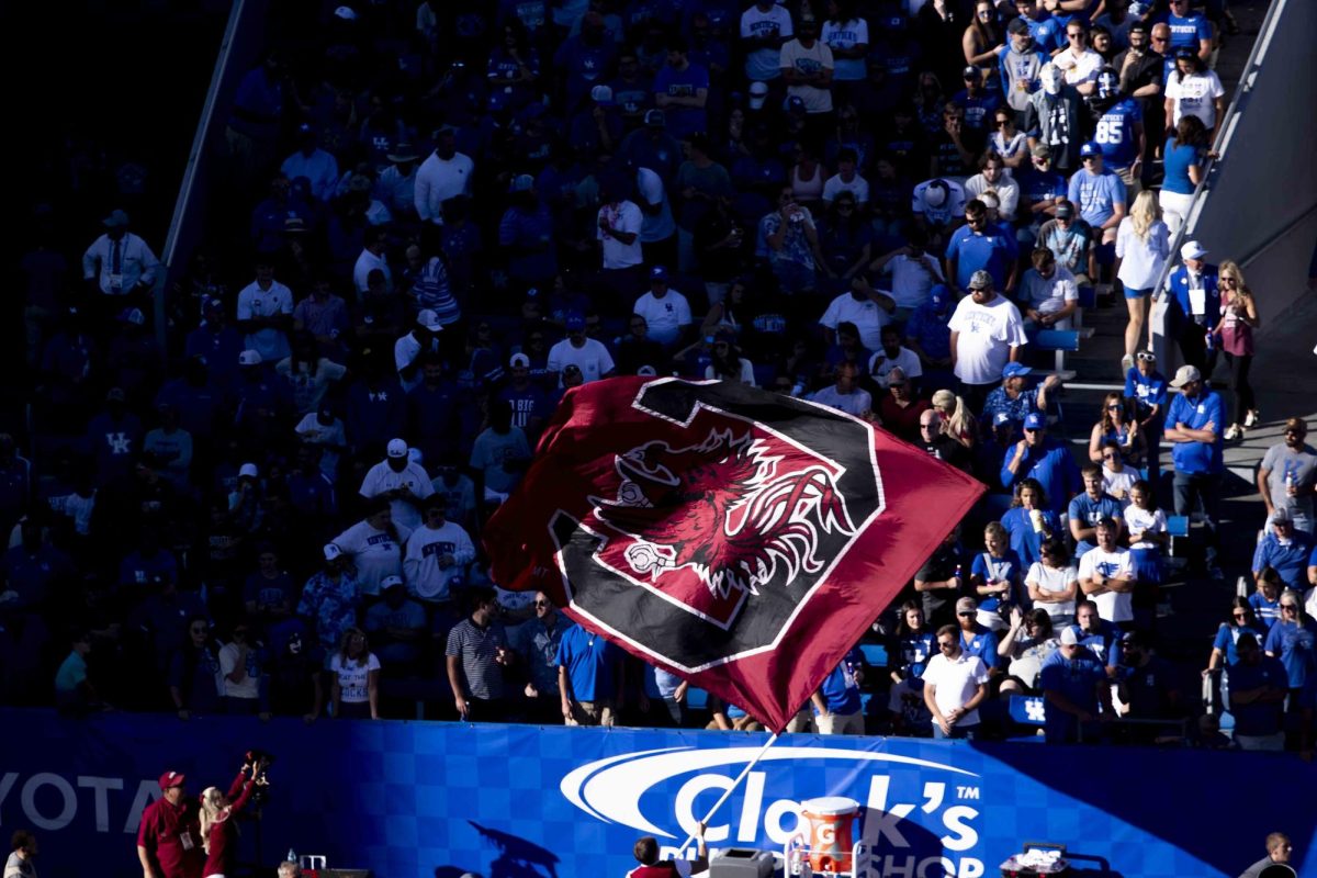 South Carolina Gamecocks cheerleader waves the Gamecocks flag after a touchdown during the game between Kentucky and South Carolina. Kentucky lost to South Carolina 31-6. Saturday, Sept. 7, 2024, at Kroger Field in Lexington, Kentucky. Photo by Matthew Mueller | Photo Editor