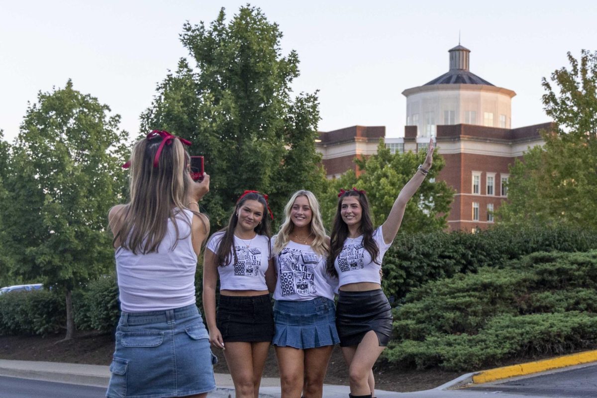 Members of Delta Zeta pose for a photo while waiting for new members to arrive during bid day on Monday, Sept. 9, 2024, at Greek Row in Lexington, Kentucky. Photo by Matthew Mueller | Staff