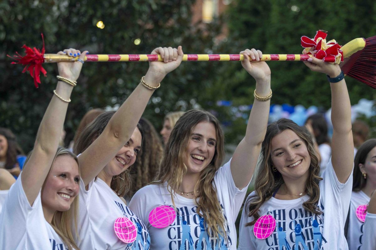 Members of Chi Omega hold a broom to show they “swept: on recruitment during bid day on Monday, Sept. 9, 2024, at Greek Row in Lexington, Kentucky. Photo by Matthew Mueller | Staff