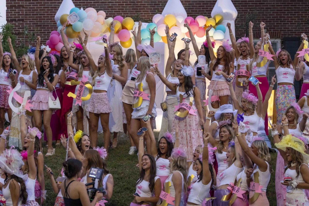 Members of Alpha Delta Pi cheer as new members pass by in buses to arrive during bid day on Monday, Sept. 9, 2024, at Greek Row in Lexington, Kentucky. Photo by Matthew Mueller | Staff